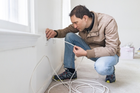 young man doing wire updates during remodeling inspection renovation